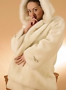 Dressed in snow-white fur this flexible babe exposes her moisten intimate places